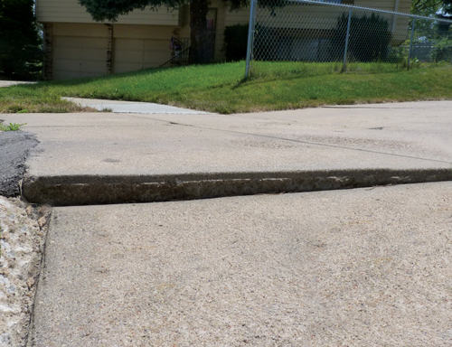 Sinking concrete sidewalk