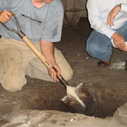 Digging a hole for the engineered fill used in a crawl space support system installation in Dalton, GA