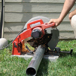 Cutting the support beam for a crawl space jack post outside a Ooltewah home.