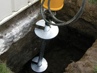 Installing a helical pier system in the earth around a foundation in Kingsport