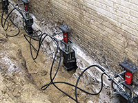 Using foundation push piers to lift a foundation during a repair in Cookeville.