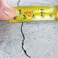 A crack in a poured concrete wall that's showing a normal crack during curing in Harrison