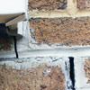 Failed crack repair showing old tuckpointing that cracked on a Johnson City home.