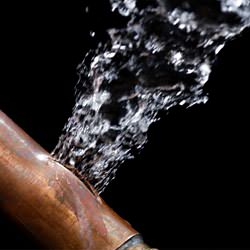 A bursting copper pipe in Kingsport, with water gushing out.