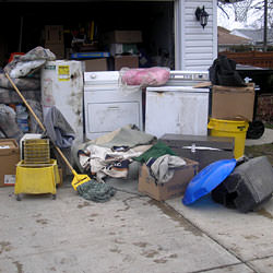 Soaked, wet personal items sitting in a driveway, including a washer and dryer in Dalton, GA.